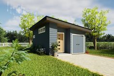 a small gray shed sitting on top of a lush green field