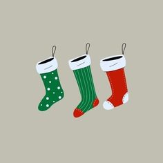 three christmas stockings hanging from the ceiling with polka dots and green, red, and white socks