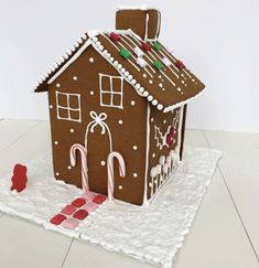 a gingerbread house is decorated with candy canes