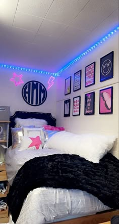 a bedroom with lights and pictures on the wall