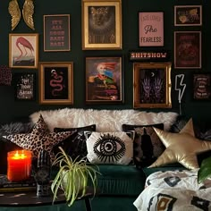 a living room filled with lots of pillows and pictures on the wall next to a green couch