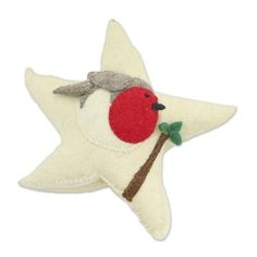 a white star shaped ornament with a red bird on it's back