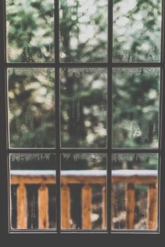 an open window with the view of trees outside