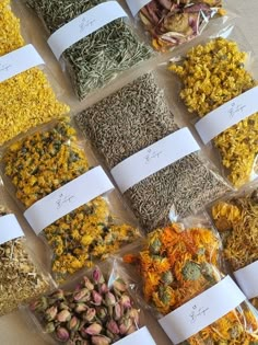 many different types of flowers and herbs in bags