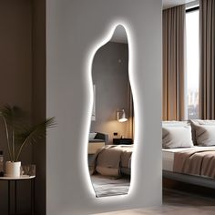 a mirror that is on the side of a wall in front of a bed with pillows