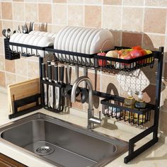 a kitchen sink with dishes and utensils hanging from it's side rack