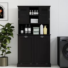 a black cabinet next to a washer and dryer