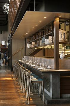 an empty restaurant with lots of counter space and chairs in front of the bar area