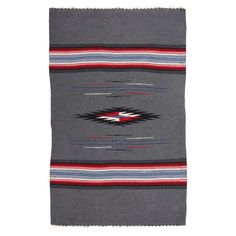 a gray blanket with red, white and blue stripes on it's edges is shown