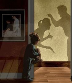 the shadow of a man holding a baby in front of a wall with pictures on it