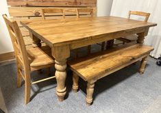 a wooden table with two benches next to it and a window in the back ground