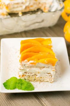 a piece of cake sitting on top of a white plate next to an orange slice