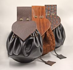 three leather purses sitting next to each other