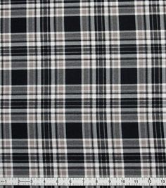 a black and white checkered fabric with a ruler on the bottom right hand side