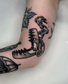 a person's foot with an anchor and chains tattoo on the left side of their leg