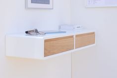 a pair of glasses sitting on top of a white shelf next to a framed photograph