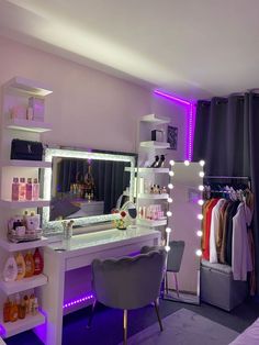 a dressing room with purple lighting and white furniture