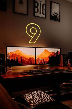 two computer monitors sitting on top of a wooden desk