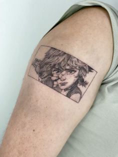 a woman's arm with a tattoo on it that has a photo of her face