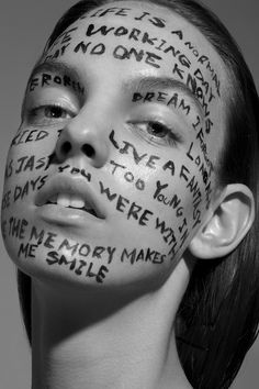 a woman with words painted on her face