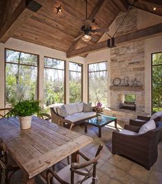 a living room filled with lots of furniture next to a fire place in a house