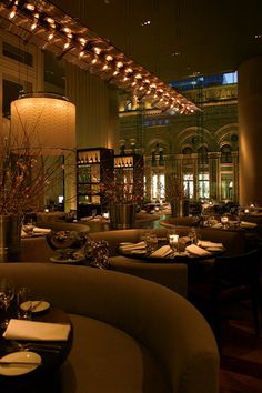 a dimly lit restaurant with tables and chairs