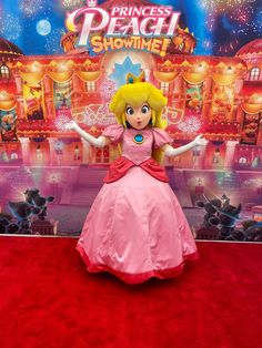 the princess peach costume is on display at disney's hollywood studios in front of a backdrop