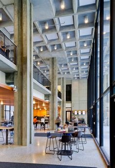 an empty lobby with tables and chairs in it