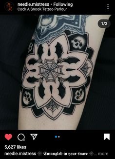 a black and white tattoo with skulls on it's arm, in the shape of a flower