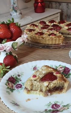 two plates with pies on them and some strawberries in the backround