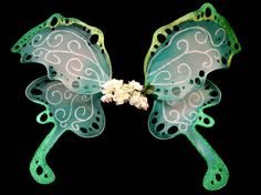 two green and white butterfly wings with flowers