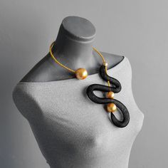 Black and golden yellow open necklace, Unusual bohemian necklace, Contemporary necklace, Modern adjustable necklace, Mesh modern necklace Beautiful open necklace in black and white combination. Modern and elegant necklace for any occasion or outfit style. Bold asymmetric necklace for lovers of distinct and unique jewelry. Necklace is light and comfortable on wire base and it can be shaped to fit perfectly to shape of your neck. Necklace length around neck: 21"/ 52 cm Please send me a message if you have any questions or doubts. I will gladly answer to you. Search out my shop maybe you will find something for your loved ones or for you. Best regards Ivana. Black Lariat Necklaces For Party, Adjustable Modern Necklaces For Party, Modern Adjustable Necklace For Party, Yellow Long Necklace For Party, Modern Handmade Necklaces For Party, Minimalist Handmade Party Necklaces, Long Gold Necklace With Unique Variations, Black Adjustable Jewelry With Unique Design, Adjustable Black Jewelry With Unique Design