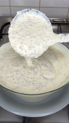 a glass bowl filled with batter on top of a stove