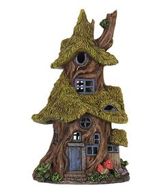 a small tree house that is made out of wood and has moss growing on the roof