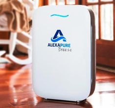 a white air purifier sitting on top of a wooden floor