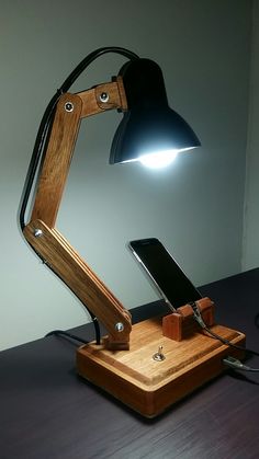 a wooden desk lamp with a cell phone on it