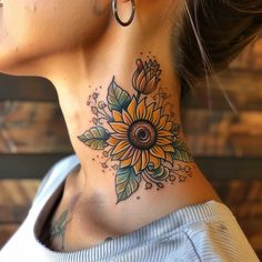 a woman's neck with a sunflower tattoo on her left side ribcage