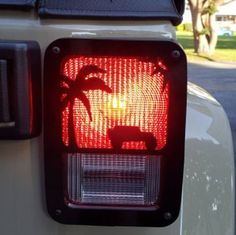 the tail light of a car with an elephant and palm tree on it