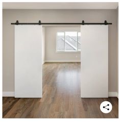 an empty room with wooden floors and sliding doors