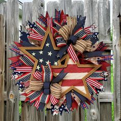 a patriotic wreath on a wooden fence