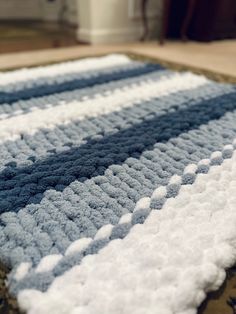 a blue and white rug is on the floor