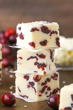 three pieces of white chocolate with cranberries on top