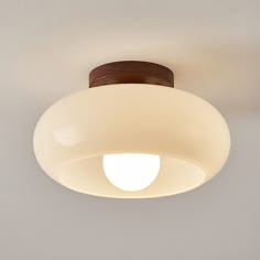 a close up of a light fixture on a ceiling with a white wall in the background