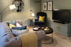 a living room filled with furniture and a flat screen tv