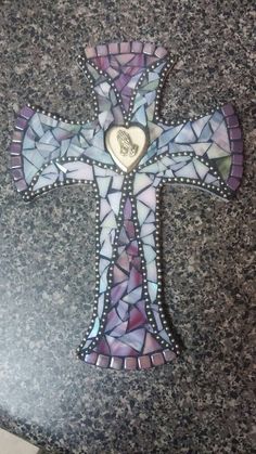 a mosaic cross with a heart on it