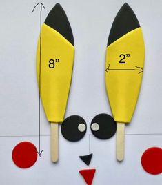 a pair of yellow and black spatulas sitting on top of a white surface