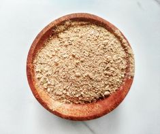 a wooden bowl filled with sand on top of a table