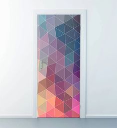 an open door with a colorful geometric design on the front and side panels, in a white room