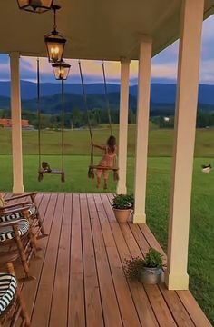 a woman sitting on a porch swing in the evening