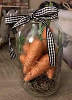 a jar filled with carrots sitting on top of a wooden table